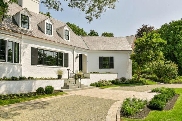 Front entryway with gravel driveway and stone walkway.