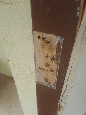 Damaged hinges with extra holes that compromise the integrity of our home.