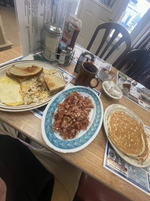 Two egg any way with corn beef hash and two pancakes