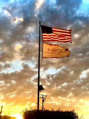 American and EZ Storage company flags blowing free in the wind.