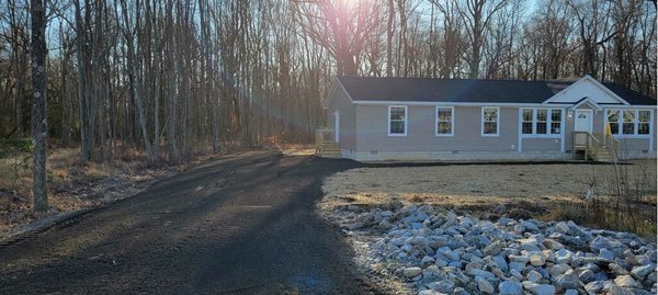 Final look at a millings driveway installed, yard graded, seeded, and straw applied (required in certain counties).