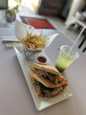 A Delicious Veggie Panini with a side of fries and ketchup and an All Natural Fresh cucumber drink.