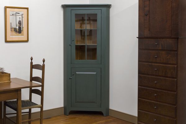 Painted Old Blue over Red, this Small Corner Cabinet is available in other woods and finishes...it is also available without the glass door