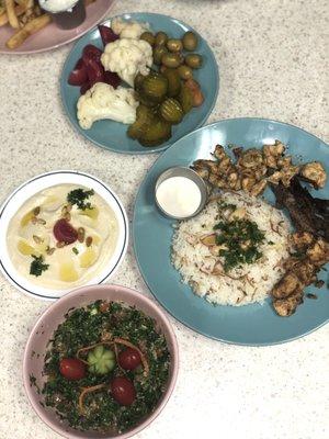 This is the shish tawook dish with rice and tahini sauce with hummus plate and some delicious fresh from the oven zuzu bread