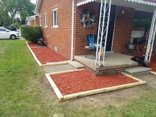 After -  removed shrubs, trimmed bush, removed garden bed boarder and installed new one Put down weed barrier fabric uninstalled fresh mulch