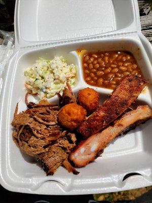 Ribs and brisket with coleslaw, beans and hush puppies.  Shredded brisket is unique.