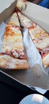 Slice of pizza ~so large, they Slice it in half!