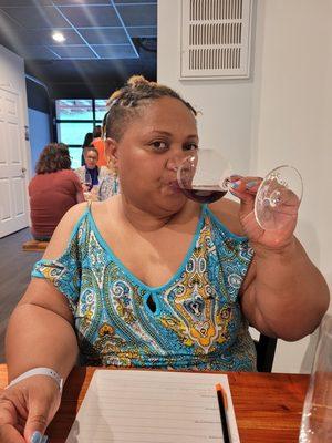 My wife sipping her wine sample