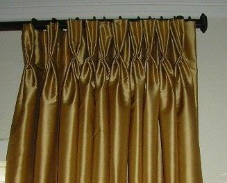 Pinch pleated silk draperies on custom iron hardware