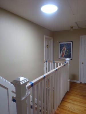 Sun tube and a new railing brighten this otherwise dark hallway.