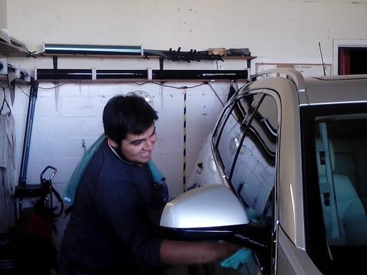 Pablo tinting a vehicle for Linus Cadillac