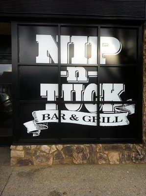 A custom weather resistant Nip n Tuck window sign for a local bar & grill in Long Branch, NJ.