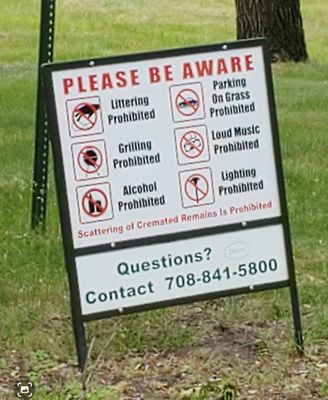 Trashy sign at the entrance and throughout the cemetery