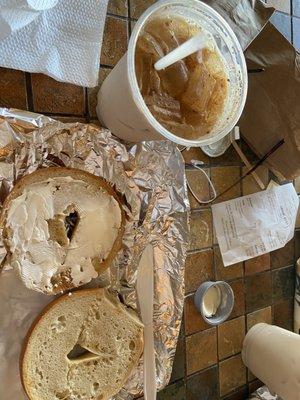 Plain toasted bagel and cream cheese with small iced chai latte.