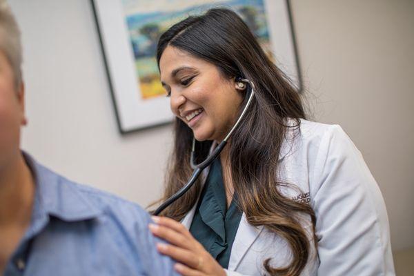 Medical Oncologist Dr. Reena Patel gives an exam to an Augusta Oncology patient.