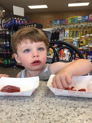 He looks happy eating at the grill