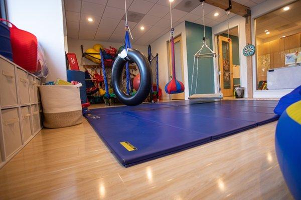 Kinder Clinic's sensory integration gym offer a wide variety of suspended equipment, climbing structures and a trampoline.