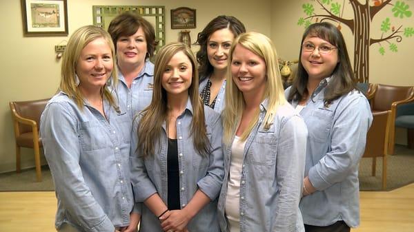 The front desk and billing team get together for a group shot.