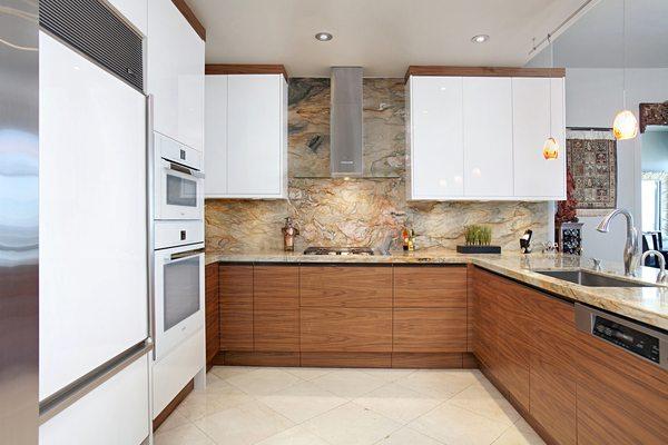 A full Miele package, walnut and white high gloss cabinetry, book-matched stone and a continuous pull make this downtown condo.