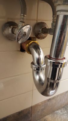 Lavatory sink trap replacement including brass trap adapter.