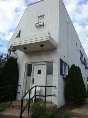 A blocked, unused entrance,  facing Willow Avenue.