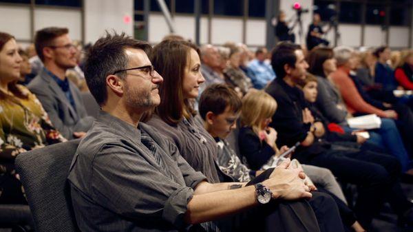 Families during Bible teaching message at Charis Christian Center church.