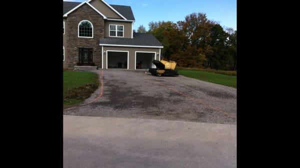 This is a drive way that has been graded with crushed stone and ready for asphalt