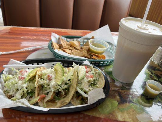 Shrimp tacos and passion fruit agua fresca drink