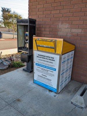 Ballot box next to a phone