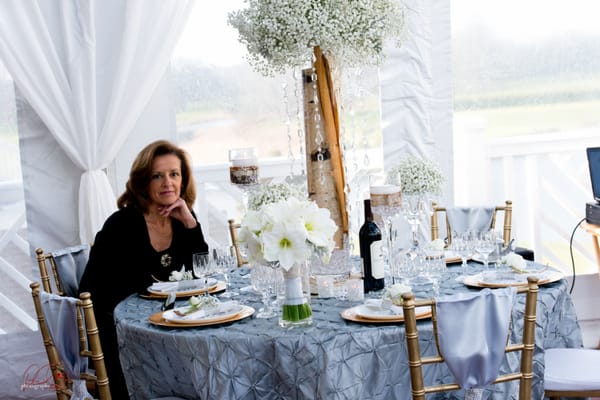 Xenia enjoys a moment at her table scape design for a recent bridal fair.