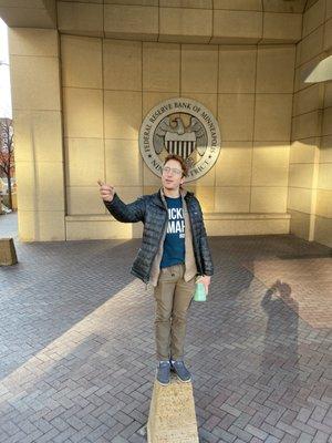 Avery in front of the Federal Reserve Building