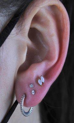 Elevate your style with a stacked ear lobe piercing. Unlock endless possibilities for a bold and edgy look. Piercings by Kirsten