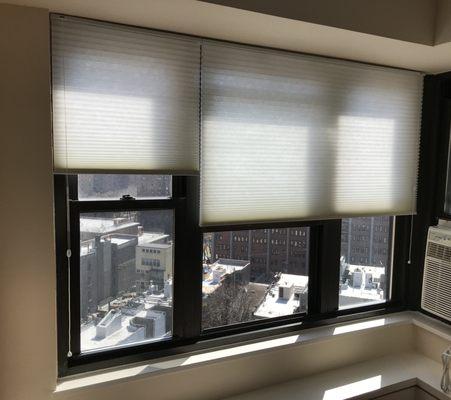 Installation of light filtering cellular shades.