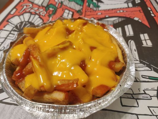 Old Burnt Fries covered with Cheese and ketchup. Shame on you for selling me this Garbage!!