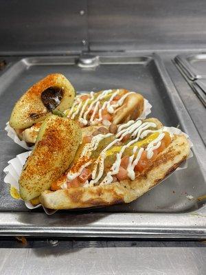 Perfect pair of our mouthwatering Sonoran Dogs topped off with house seasoned roasted yellow peppers