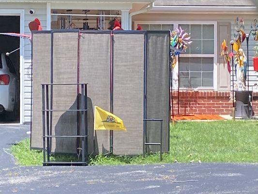 looking like trailer park trash with a bookcase and end table and indoor screens tied up in the yards.