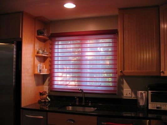 A silhouette light filtering shade in a kitchen are.