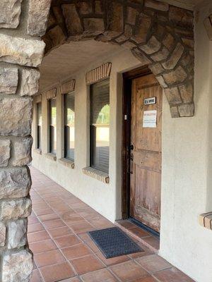 The office with a doorbell is the far North door of the North building of two buildings.