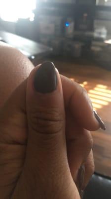 Shaved off half the acrylic nail, and instead of filing it even she left it?