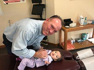 Dr. Maddigan performing an adjustment on an infant