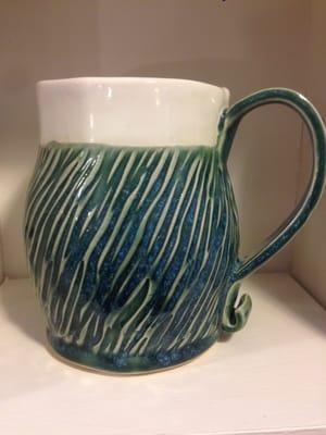 Large hand built coffee mug with comfortable strap handle.