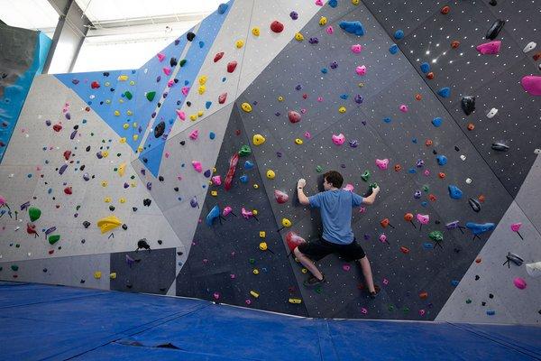 A student in our youth climbing class working on his traverse technique