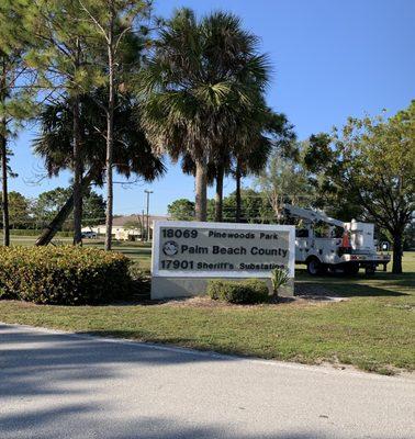 Pinewoods Park entrance at 441 & Clint Moore. The entrance has a street light.