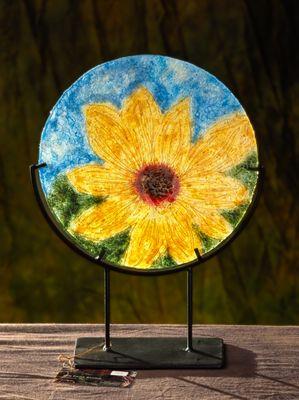 The sunflowers from Ukraine.  Wool fibers sewn together,  mounted on  glass.