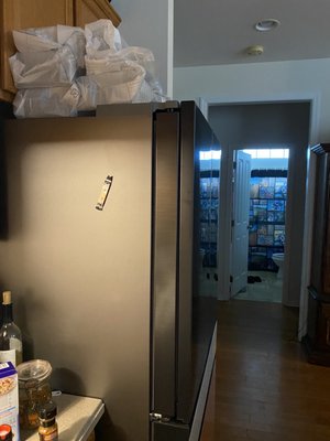 This is the oversized fridge with the unwrapped shelves still on top since july 6 . Sent the wrong one and then said don't move it .