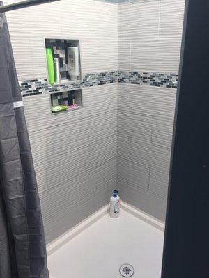 Bathroom Shower unit with ceramic tile, niche insert and new satin nickle faucet installed in downtown Cincinnati Condo.