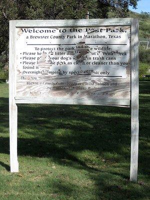 The old wooden sign with the rules of the park