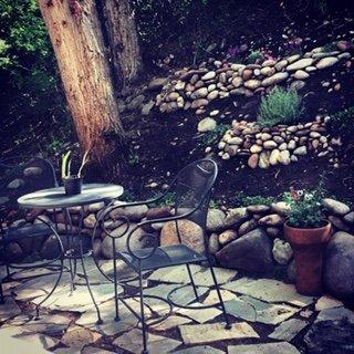 Garden and Patio Installation using recycled river rock from hillside.