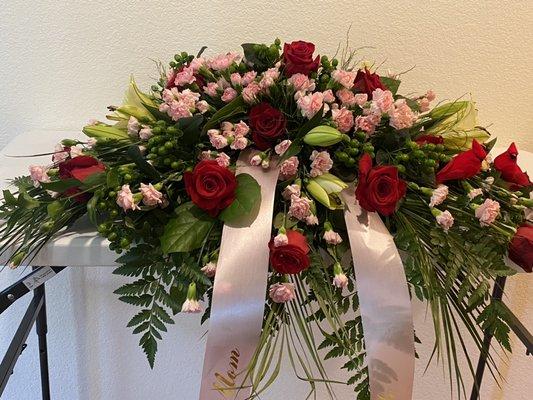 Red rose and pink carnation with lily casket spray