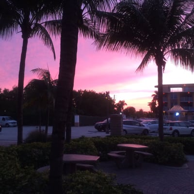 View of the sunset after yoga on the beach. T.SULLIVAN community center Building and tervanna pool and tiki bar